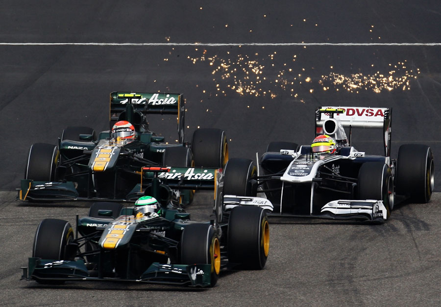 Sparks fly as Jarno Trulli and Heikki Kovalainen take on Pastor Maldonado