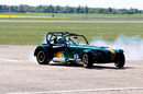 Heikki Kovalainen at the wheel of a Caterham 7 at the announcement of Tony Fernandes' purchase of Caterham