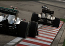 Nick Heidfeld holds off the Mercedes of Michael Schumacher through the final corner
