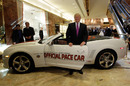 Donald Trump poses for photographers with a replica of the 2011 Indianapolis 500 Chevrolet pace car