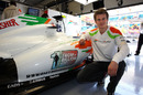 Nico Hulkenberg shows off the Force India 'One from a billion' search being displayed on the car