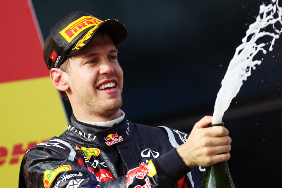 Sebastian Vettel sprays champagne on the podium