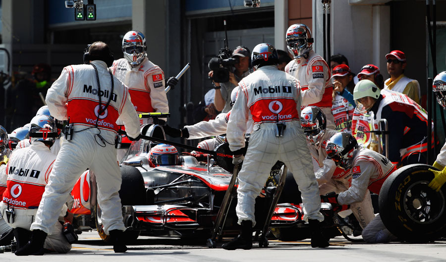 Jenson Button pits for a new set of soft tyres