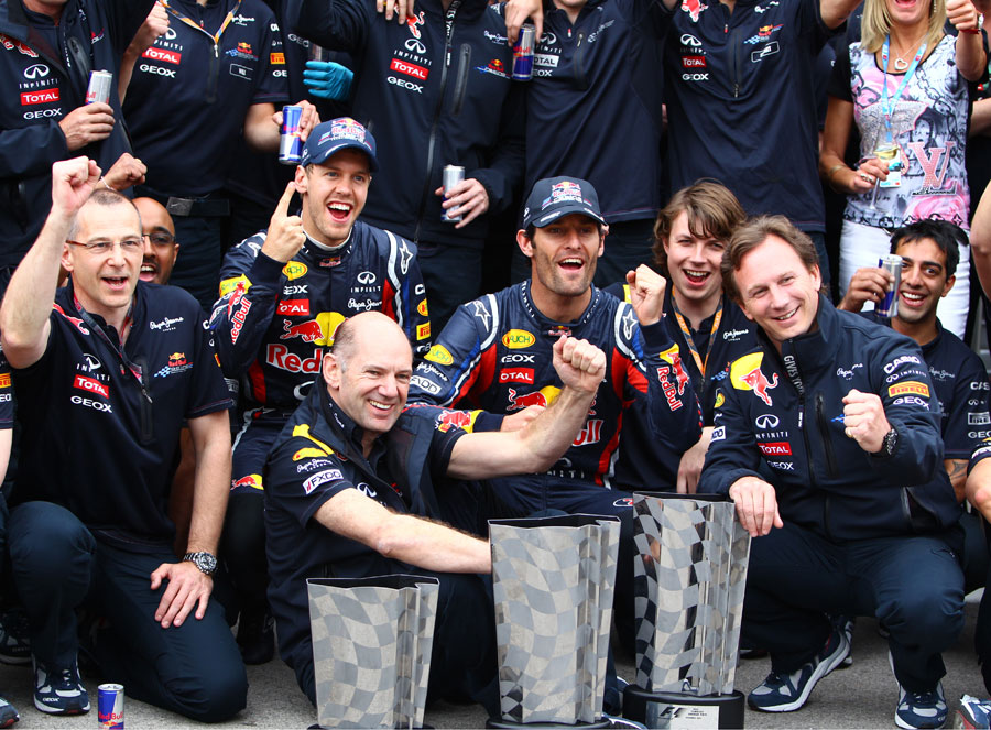 Sebastian Vettel and Mark Webber celebrate with Christian Horner, Adrian Newey and the rest of the Red Bull team
