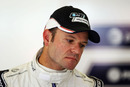 Rubens Barrichello waits patiently in the Williams garage on Friday