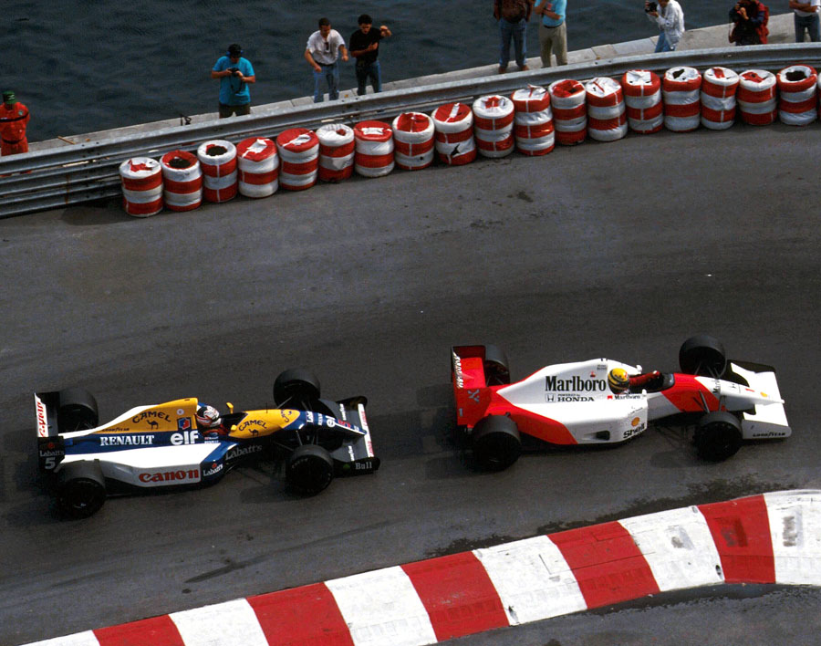 Ayrton Senna holds off Nigel Mansell for the lead