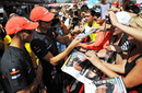 Jenson Button and Lewis Hamilton sign autographs for fans